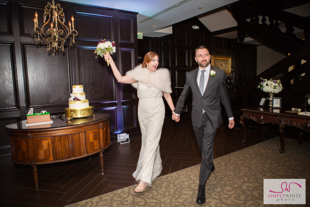 Nicole and Jason enter their downtown Tulsa wedding reception at the Summit Club